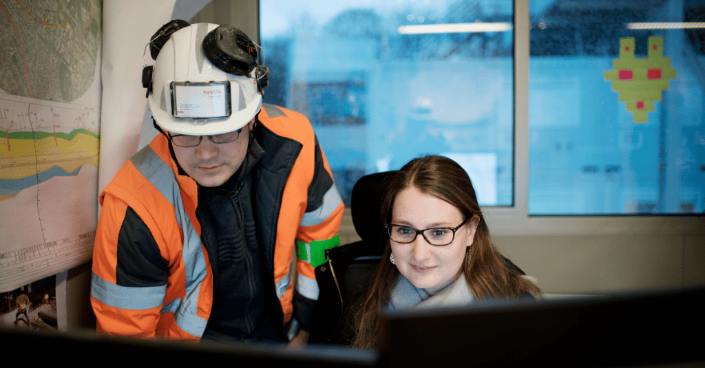 Two people at rail station office