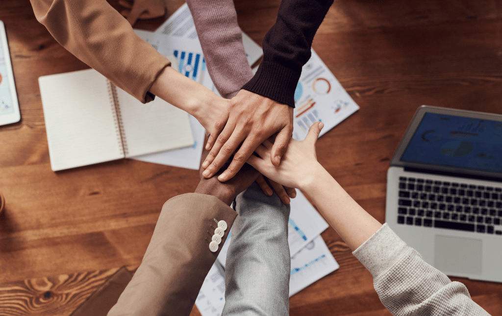 Team members joining hands