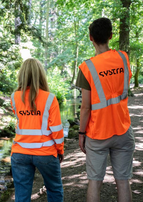 SYSTRA specialists in orange high-vis on site visit to river.